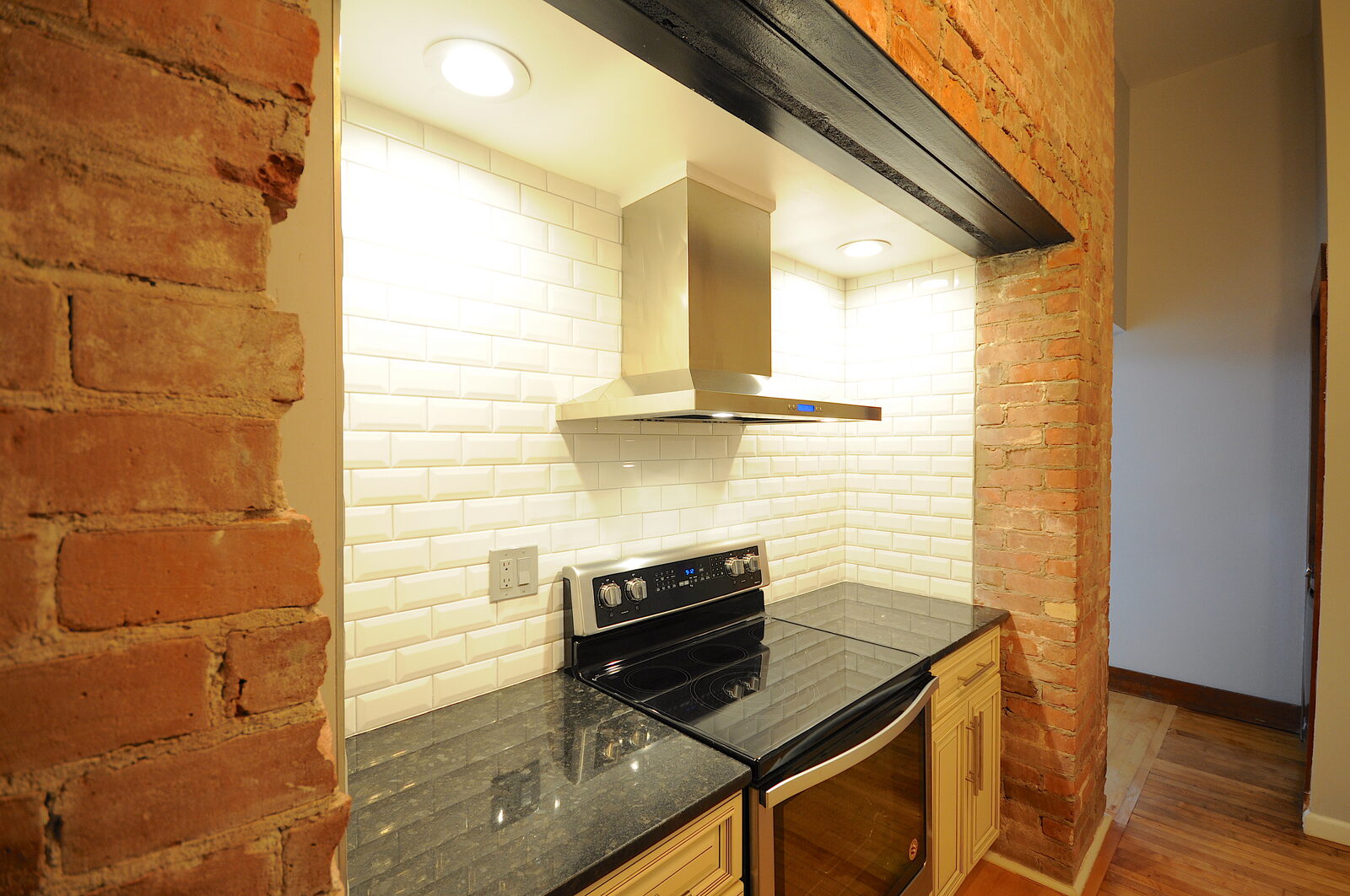 Kitchen in a Hillside Place one-bedroom residence with subway tile and stainless range